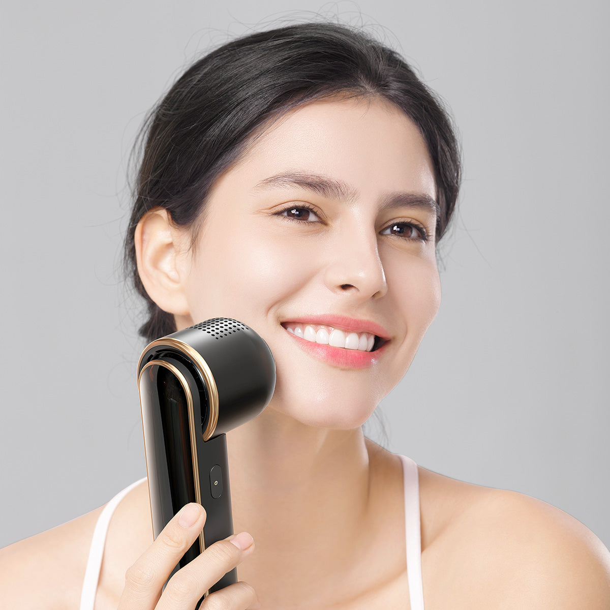Smiling woman using JOVS Blacken DPL Photofacial machine for a radiant and youthful complexion.