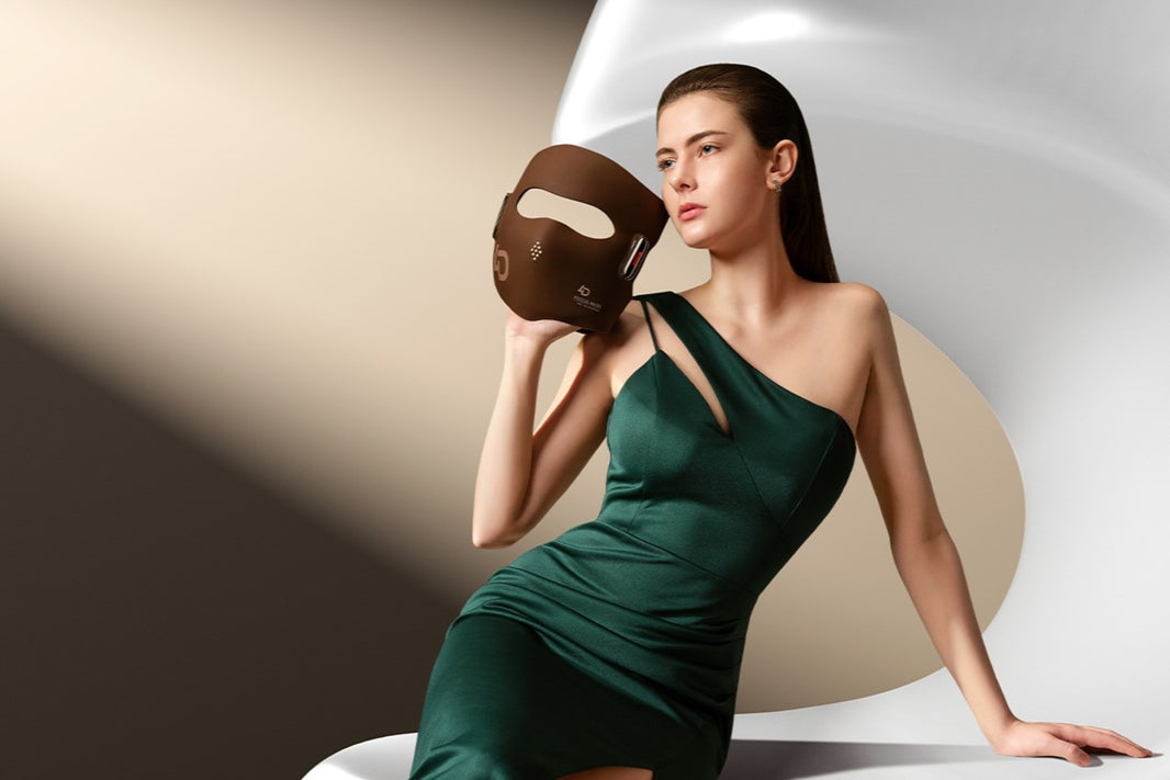 Elegant woman holding JOVS 4D Laser Light Therapy Mask as part of an advanced skin care routine.
