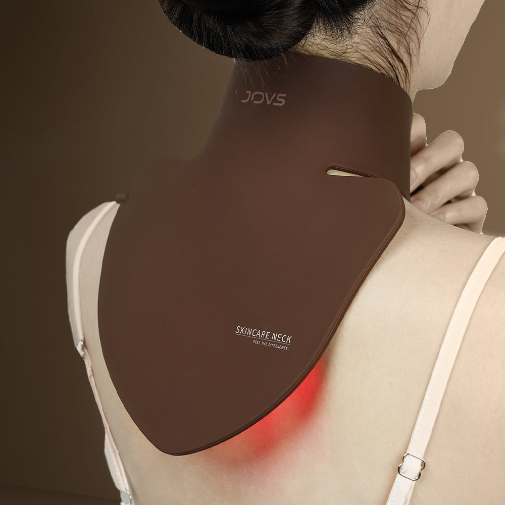 Woman using JOVS LED Neck & Chest Mask, effective for reducing neck wrinkles with red light therapy.