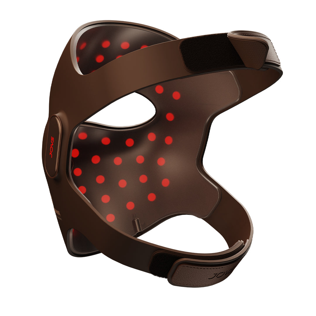 Close-up of the JOVS 4D Laser Mask powered on, displaying the red LED lights for effective photorejuvenation treatment.