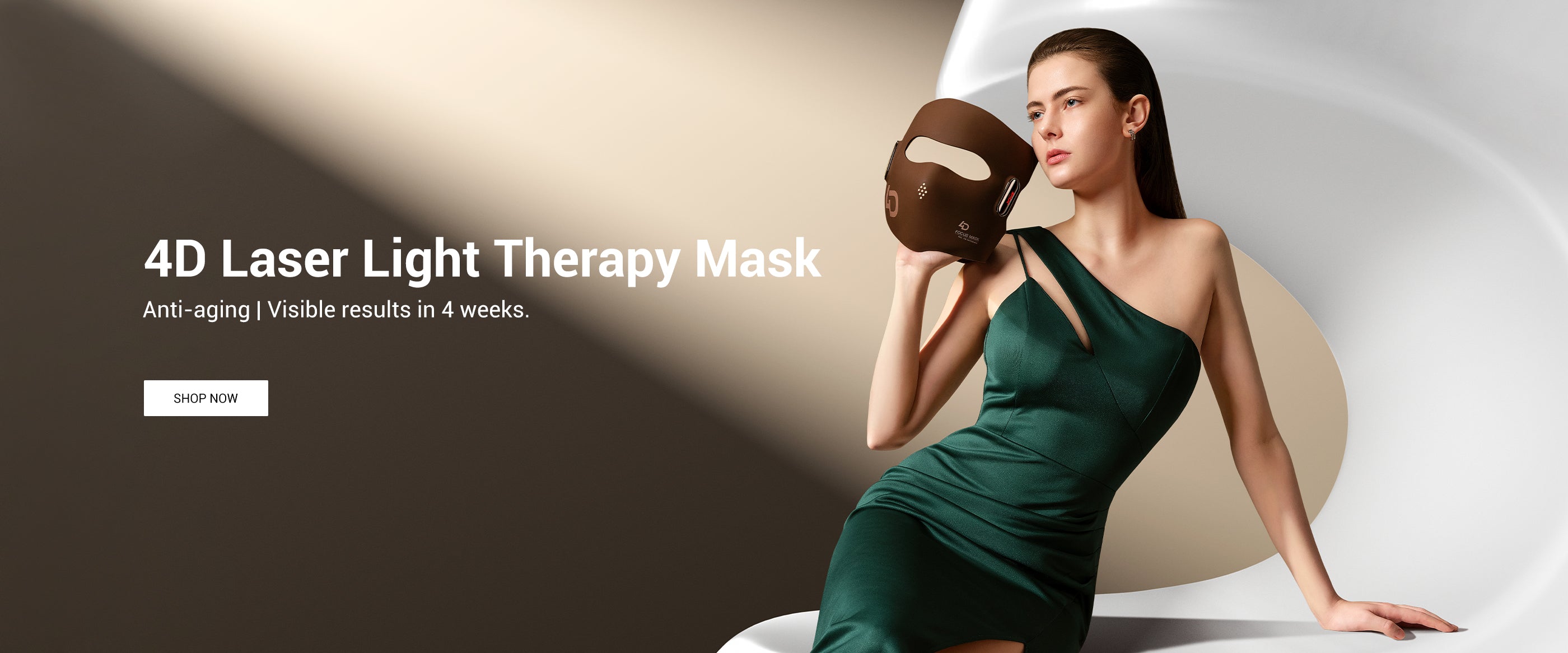 A sophisticated woman in an emerald dress holding the JOVS 4D Laser Light Therapy Mask, promising anti-aging and visible skin improvement in 4 weeks.