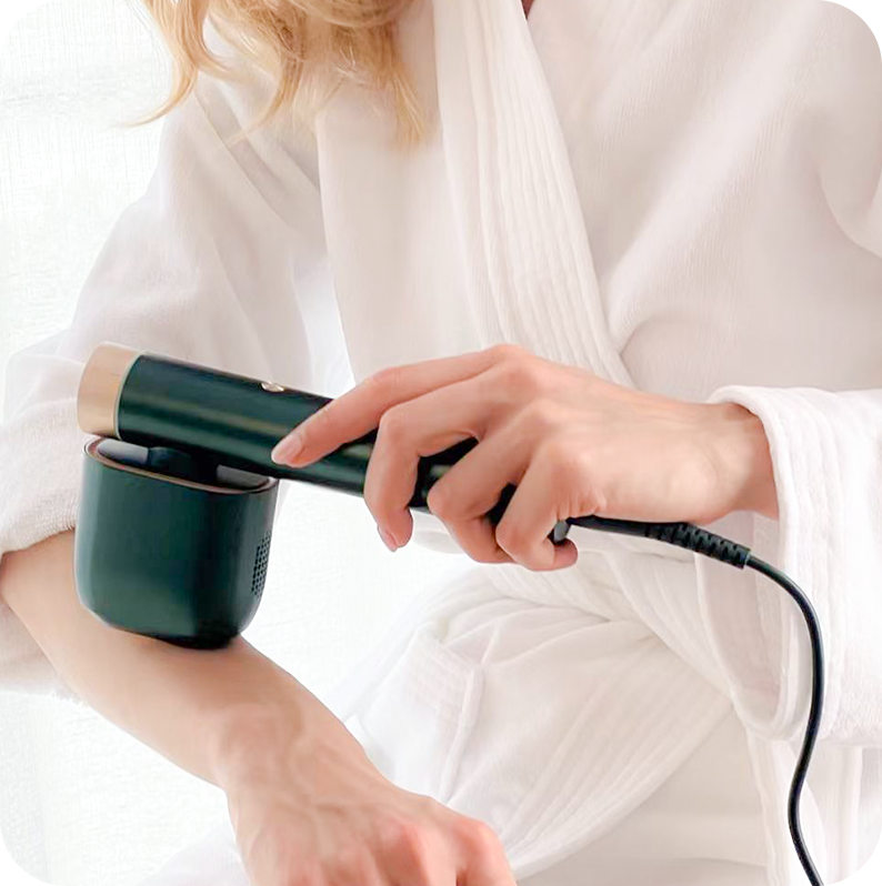 Woman using JOVS Venus II IPL hair removal device on arm, showcasing the product's functionality and ergonomic handle.