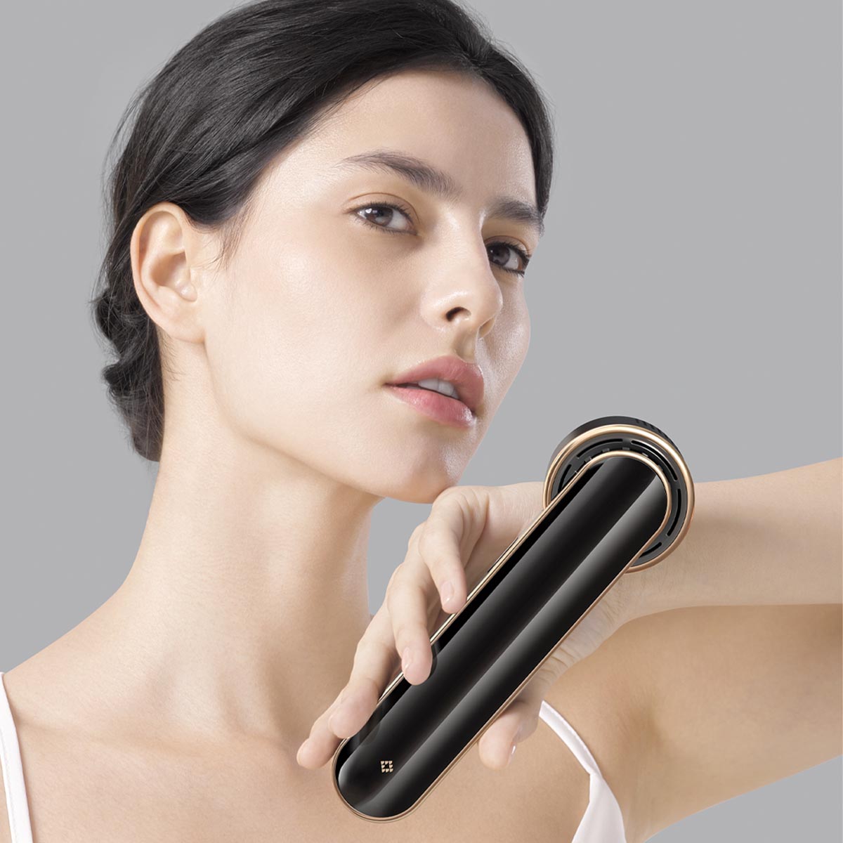 Woman using JOVS Blacken DPL Photorejuvenation Device on sensitive skin for a pain-free photo rejuvenation treatment.