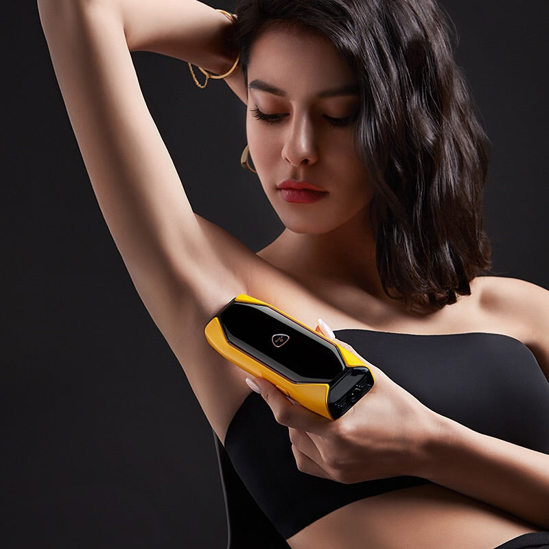 Woman using the JOVS X™ Hair Removal Handset on underarms for a smooth, hair-free appearance.